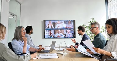 Business worker with virtual attendees in conference room