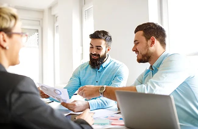 Business professionals discussing data around a conference table