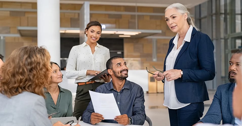 Business professionals working with charts graphs at a table