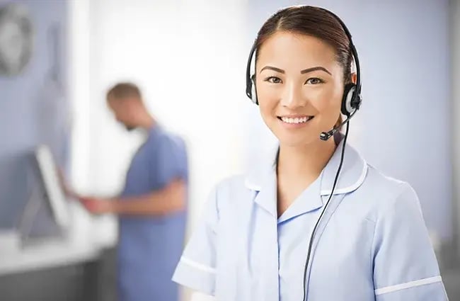 Woman smiling and wearing a telephone headset