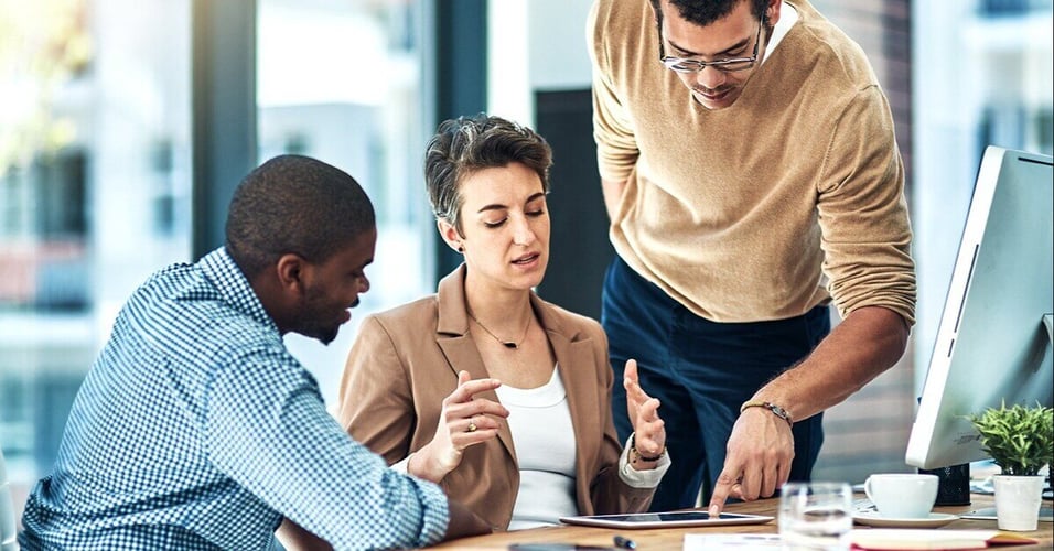 Professionals working around a tablet 