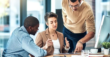 Professionals working around a tablet