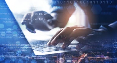 Hands typing on laptop