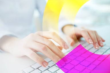 Hands typing on a laptop