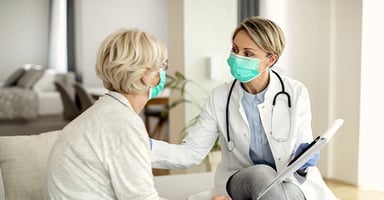 Health care worker with a patient in a home