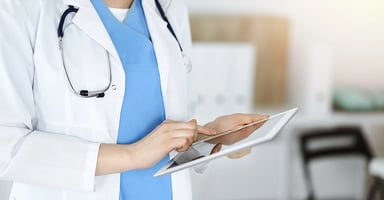 Healthcare provider working on tablet device