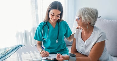 Helathcare professional working with patient.