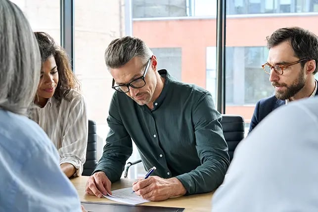 Professional business people collaborating at a conference table