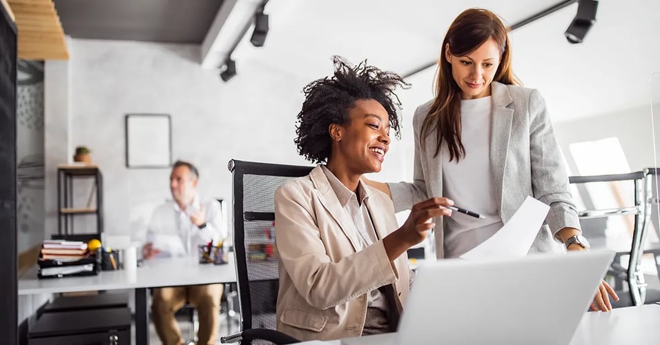 Colleagues working at a desk 