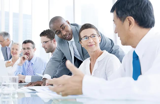 Row of professionals working at a conference table