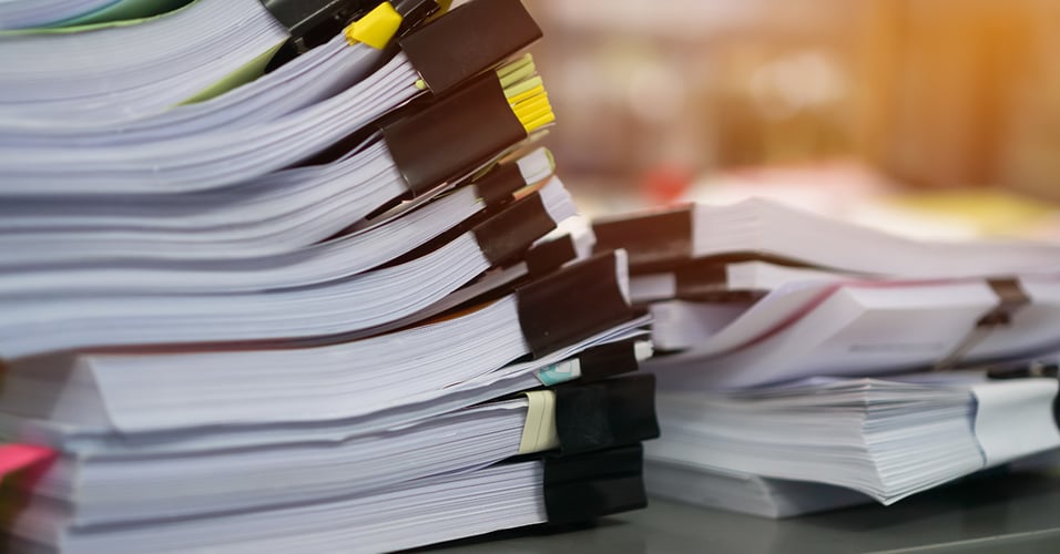 Stack of binder clipped papers