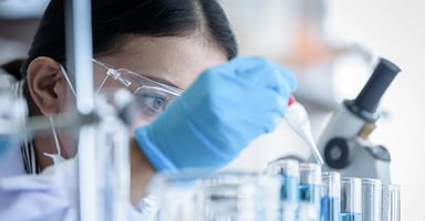 Woman focused on injecting test tube