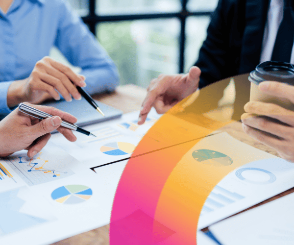 Hands pointing to a graph at a table