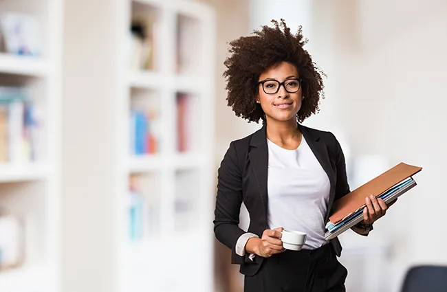 Business worker holding espresso cup and stack of papers looking forward